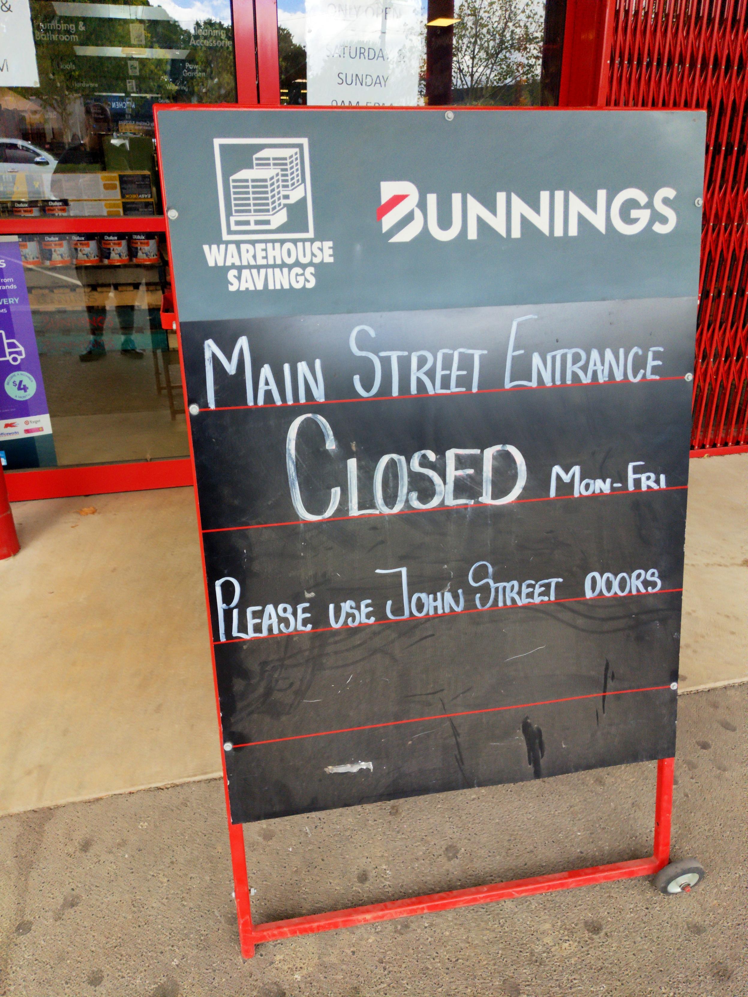 Bunnings sign saying main street entrance closed M-F