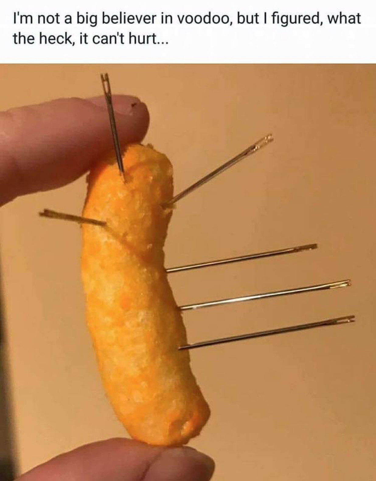 I’m not a big believer in voodoo, but I figured, what the heck, it can’t hurt. (Image: photo of a Cheeto impaled by six needles)